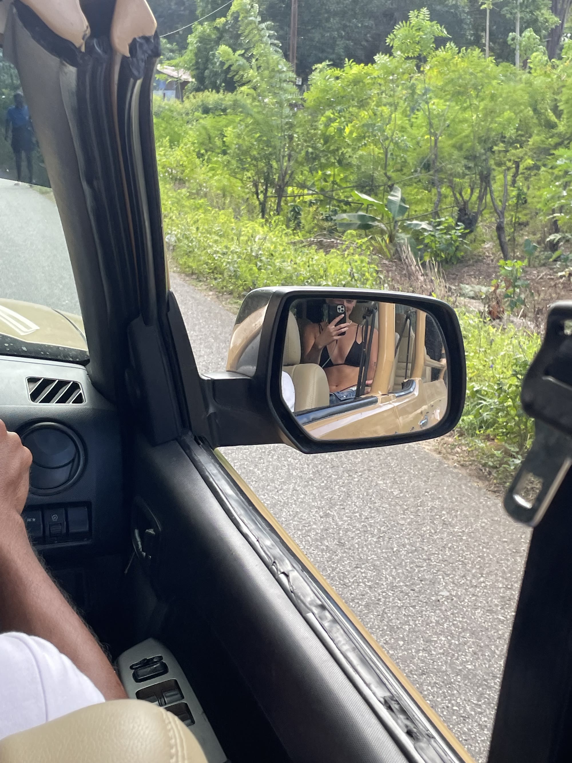 Mirror selfie riding in a jeep through Sumba's backroads