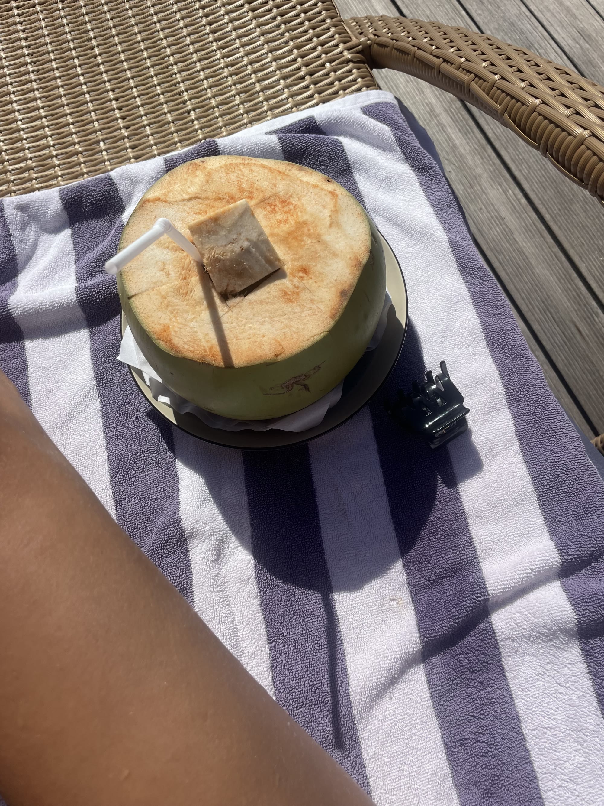 Fresh coconut with a straw, poolside at Tanoma Resort